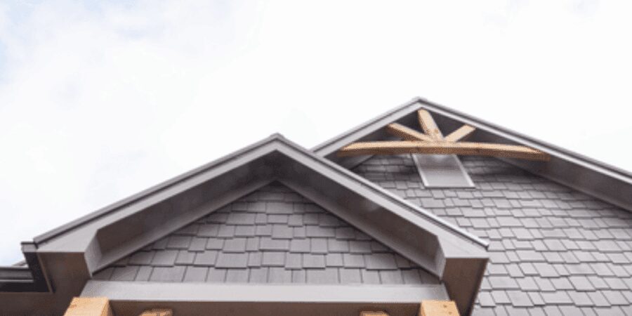 Wooden house roof against blue sky.