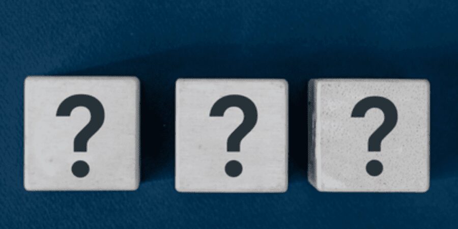 Three question mark cubes on blue background.