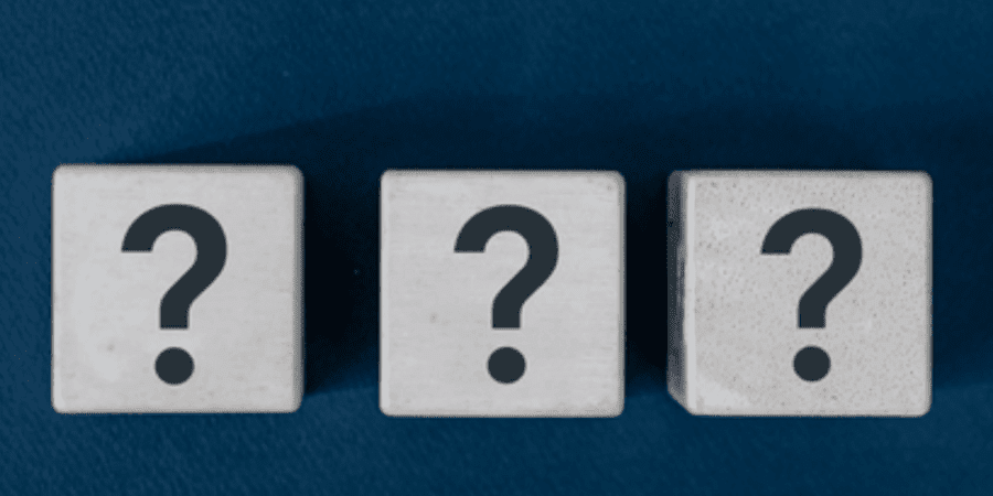 Three question mark cubes on blue background.