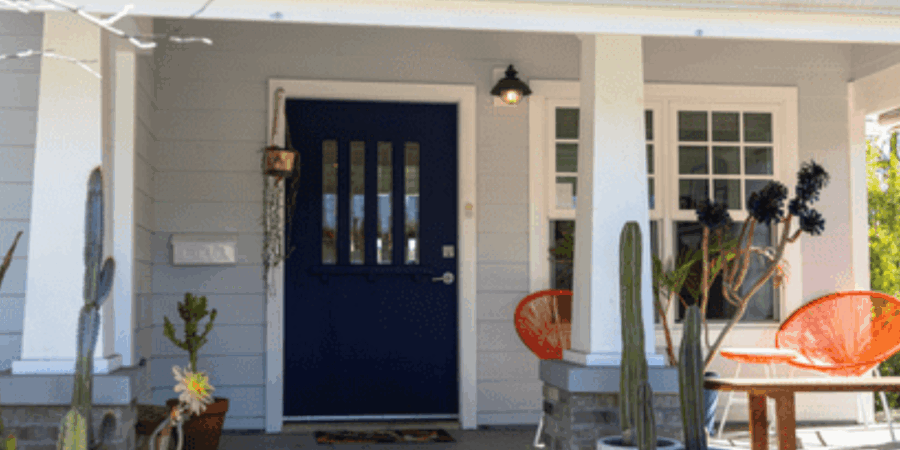 House entrance with plants and orange chairs.