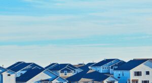Suburban houses under clear blue sky.