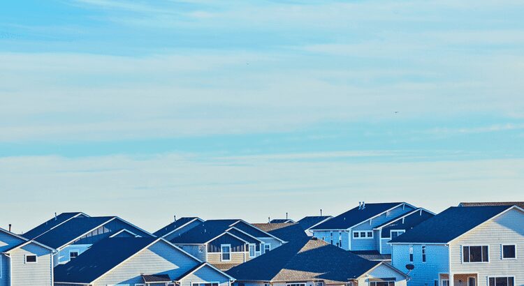 Suburban houses under clear blue sky.
