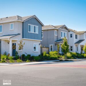 Modern suburban houses under clear blue sky.
