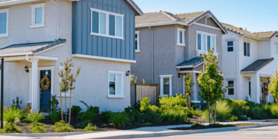 Modern suburban houses under clear blue sky.
