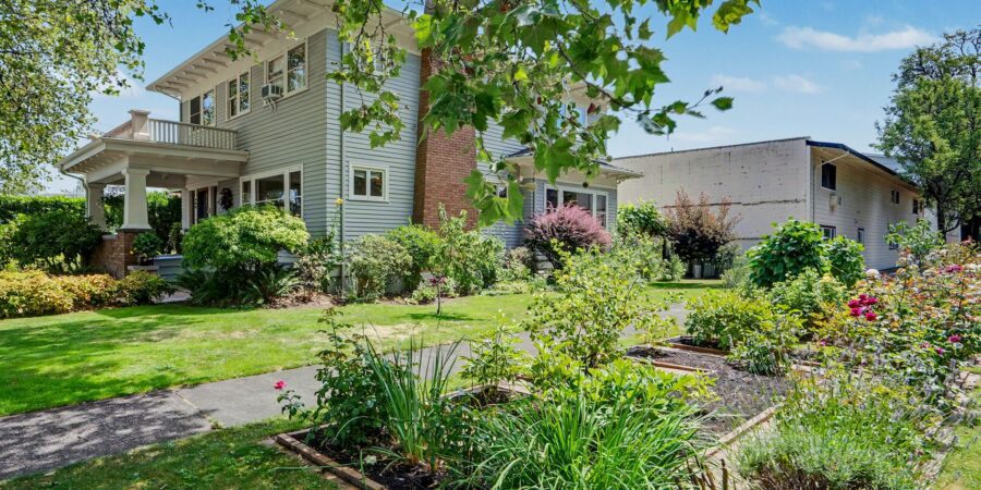 Craftsman two story home with lush front garden